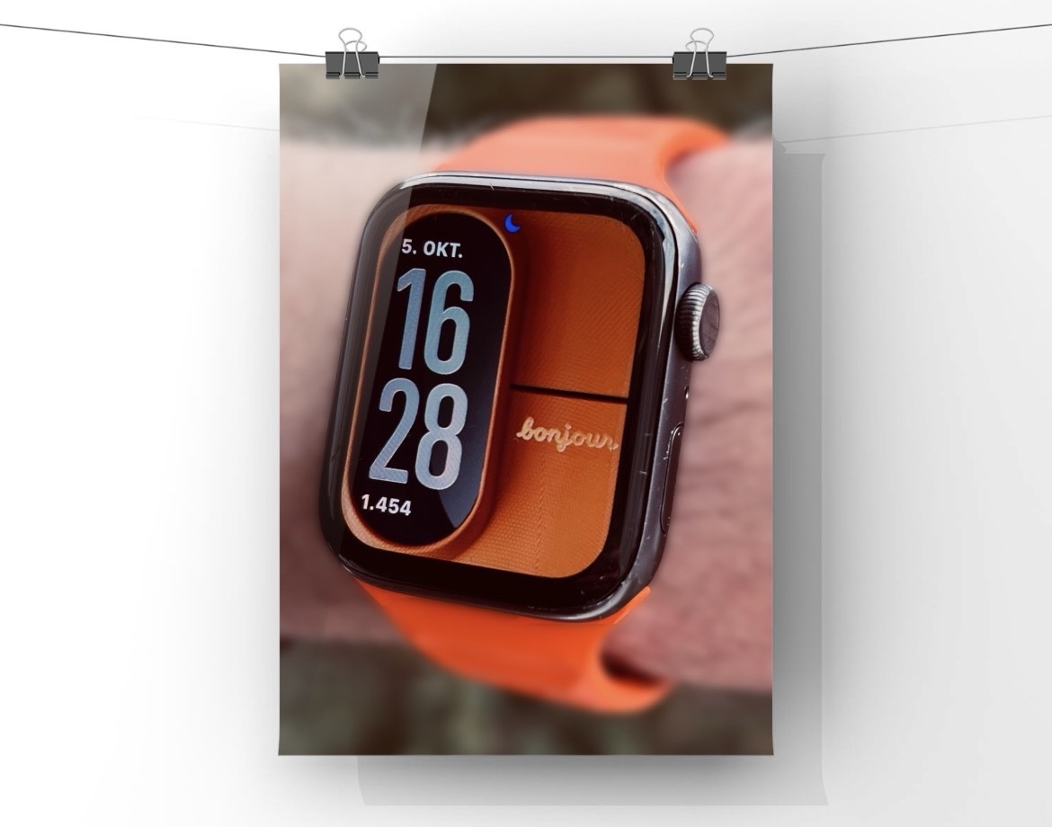 Das Cosmic Orange Hintergrundbild mit einem orangenen Armband. 